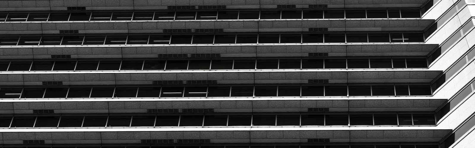 Abstract building facade with dense repeating horizontal lines